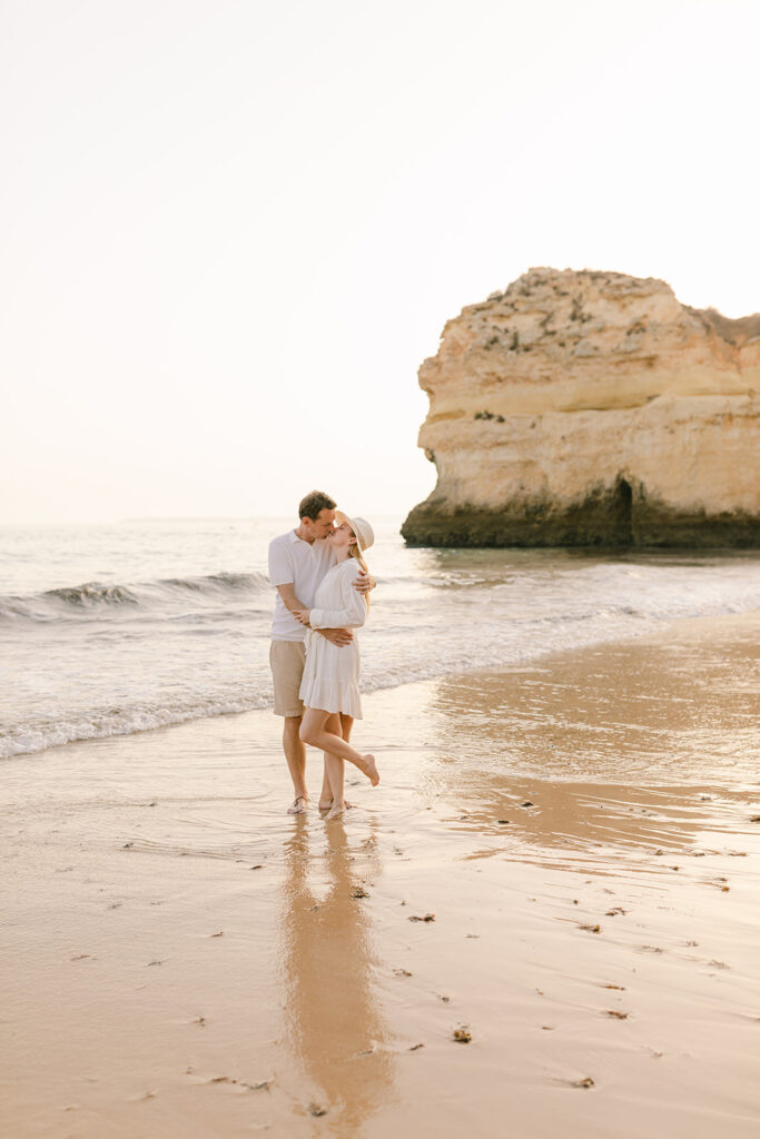 Photograph of Man and woman kissing on beach in Orange County