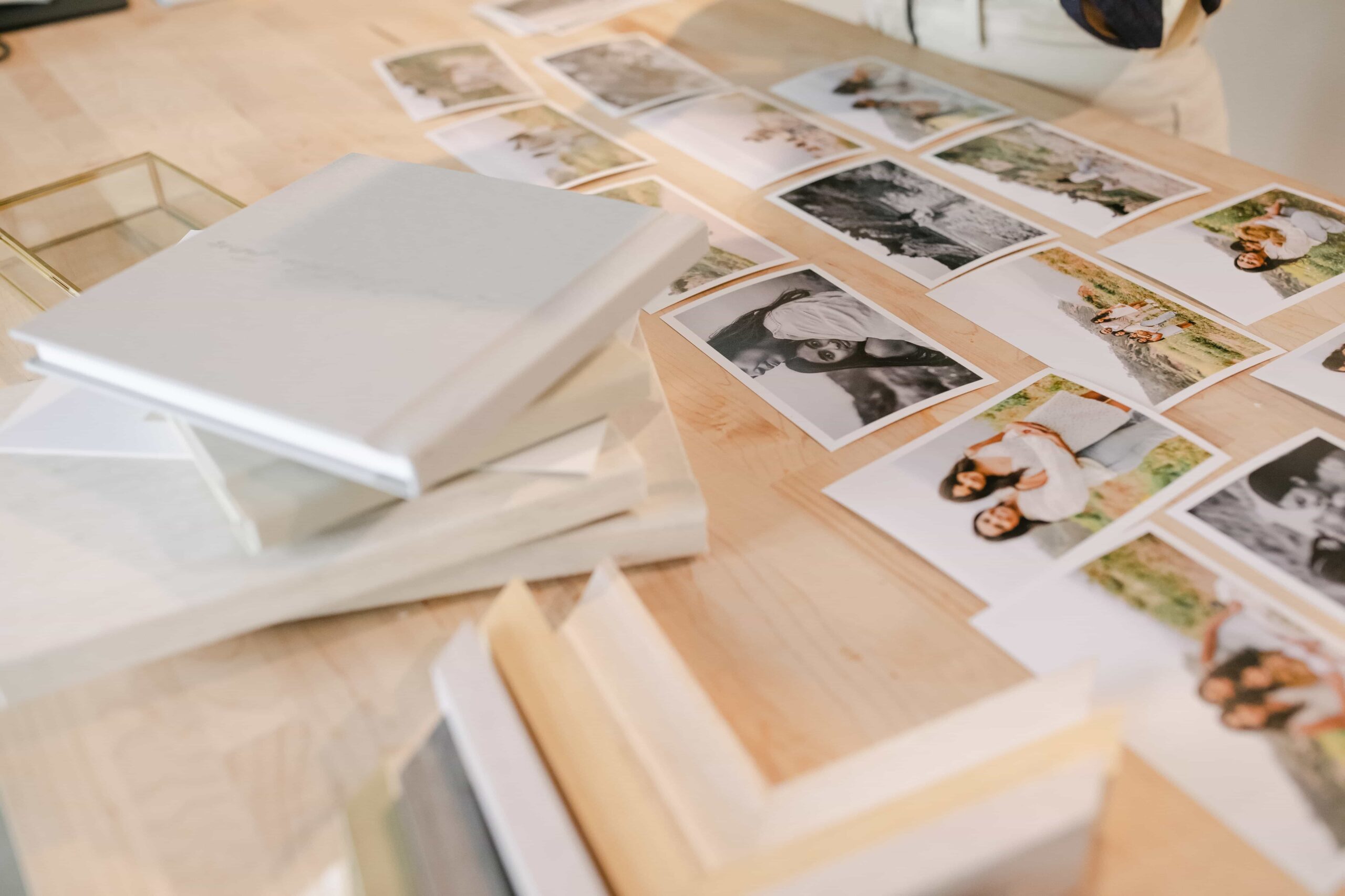 family photos arranged on a table to put in a gallery