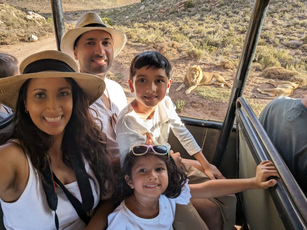Photo of a smiling family with two young children visiting South Africa.