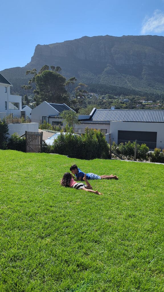 Sondagar children relax in South Africa with Table Mountain in the background